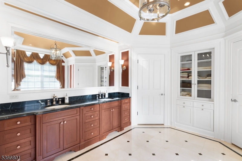 4 Rainetree Ridge Mendham Township, NJ 07945 - Photo 27 of 49 a bathroom with a double vanity sink and a mirror