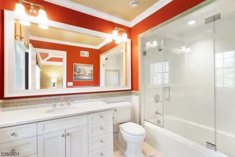 a bathroom with a granite countertop sink a toilet and a bathtub