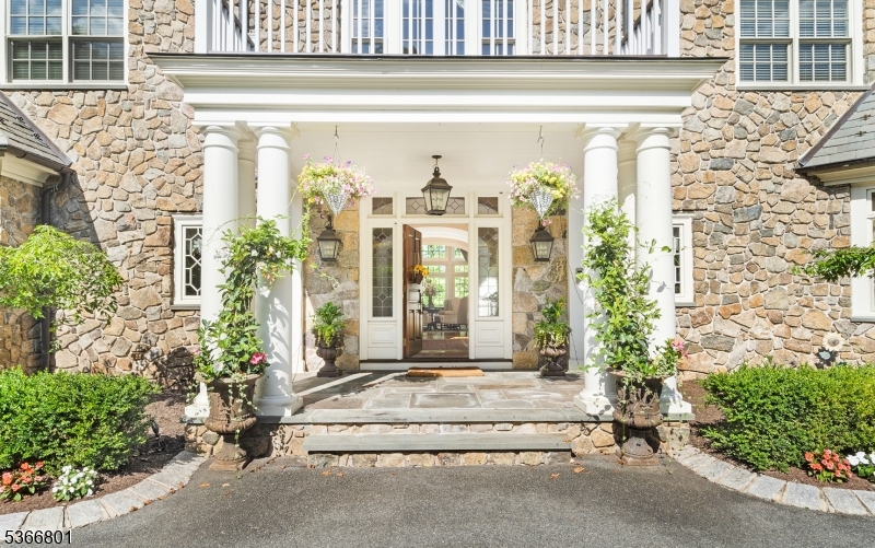 4 Rainetree Ridge Mendham Township, NJ 07945 - Photo 4 of 49 a front view of a house with a garden