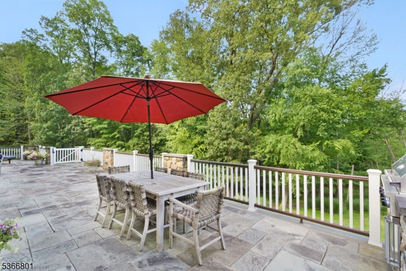 4 Rainetree Ridge Mendham Township, NJ 07945 - Photo 46 of 49 a view of a patio with furniture and a garden