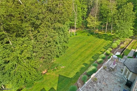 an aerial view of a house with a yard and lake view