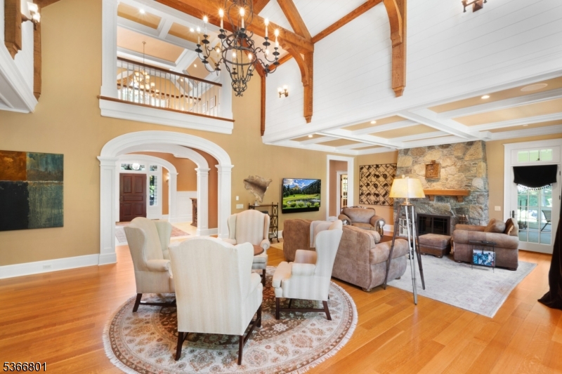 4 Rainetree Ridge Mendham Township, NJ 07945 - Photo 9 of 49 a living room with fireplace furniture and a chandelier