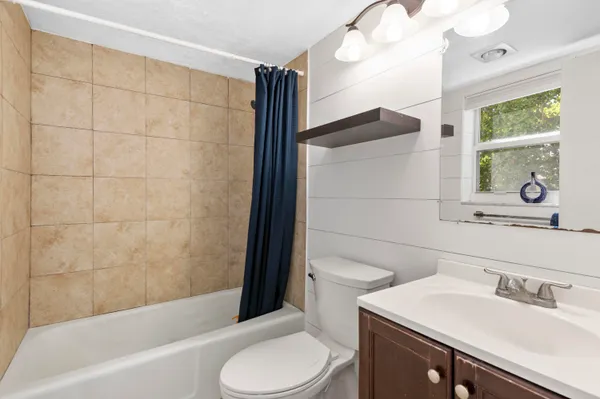a bathroom with a toilet and shower