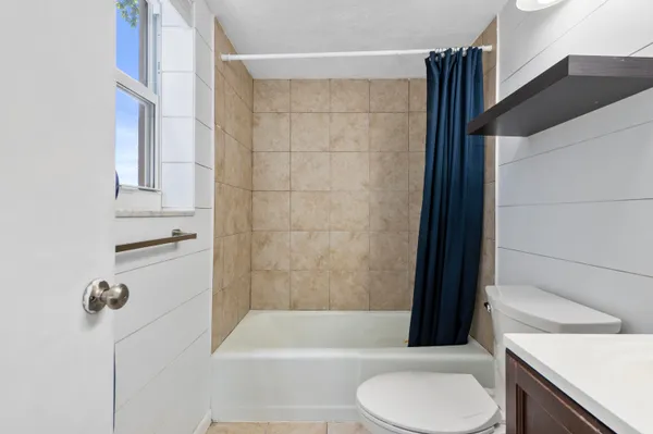 a bathroom with a toilet a sink and a mirror