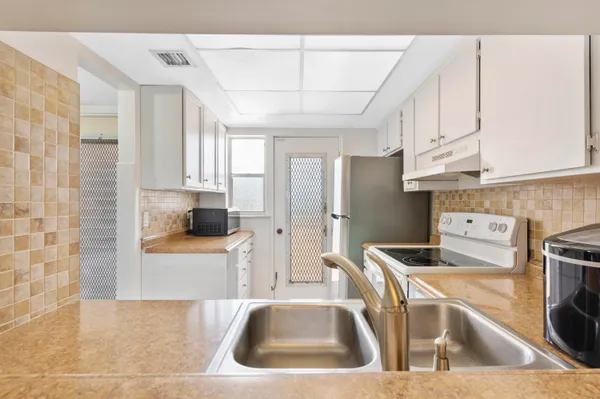 a kitchen with stainless steel appliances granite countertop a sink and cabinets