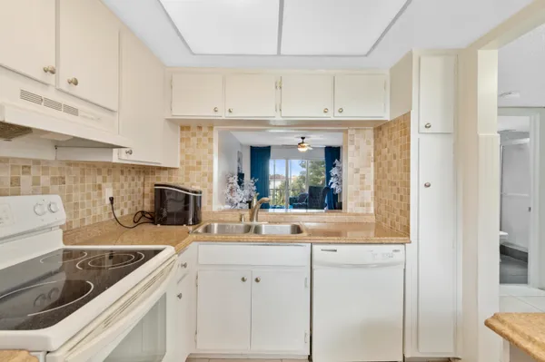 a kitchen with stainless steel appliances granite countertop a sink and a microwave