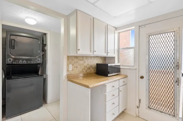 a kitchen with cabinets stainless steel appliances and wooden floor