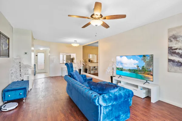 a living room with furniture and wooden floor