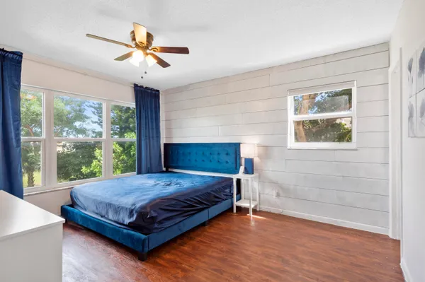 a bedroom with a large bed and a chandelier