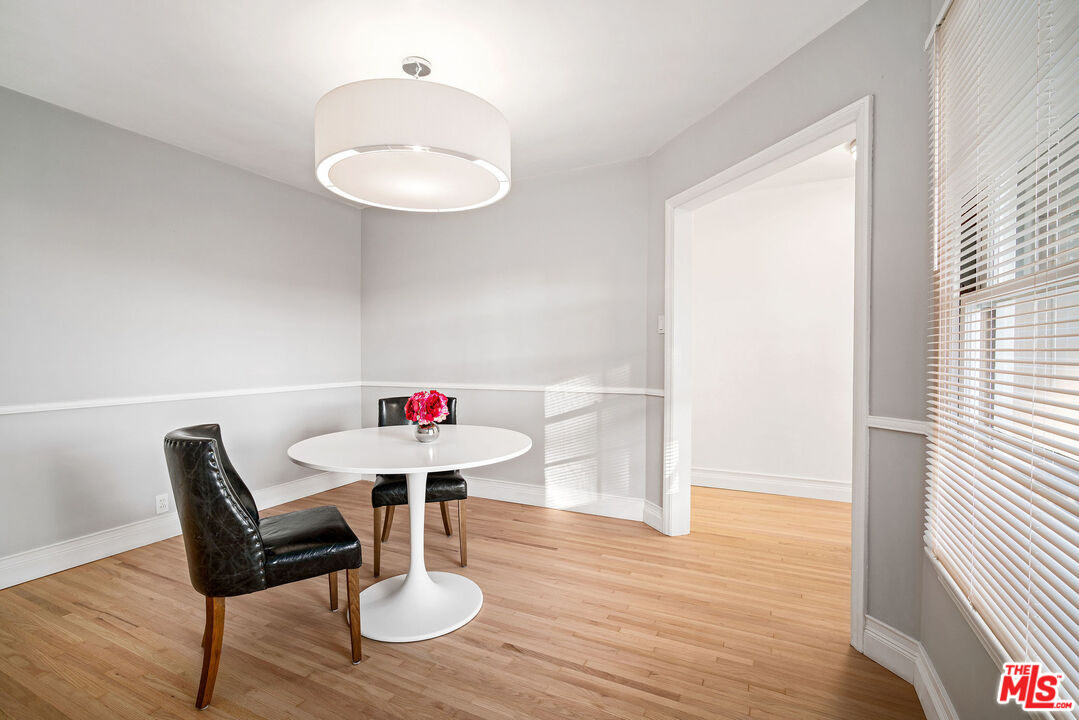 1924 Armacost Avenue Los Angeles, CA 90025 - Photo 14 of 33 a view of a dining room with furniture and wooden floor