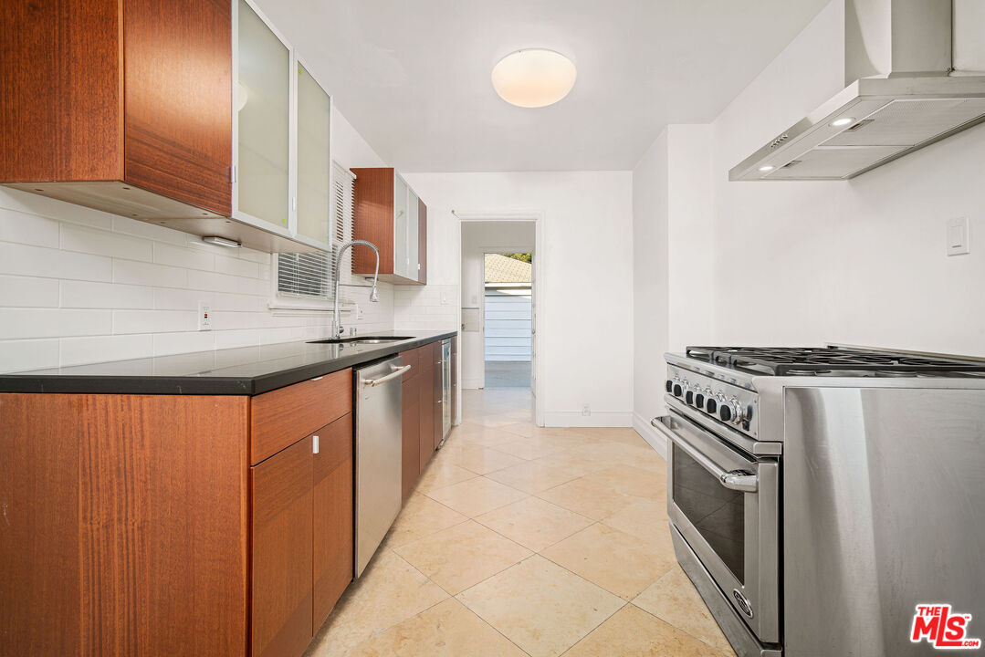 1924 Armacost Avenue Los Angeles, CA 90025 - Photo 17 of 33 a kitchen with stainless steel appliances granite countertop a sink stove and refrigerator