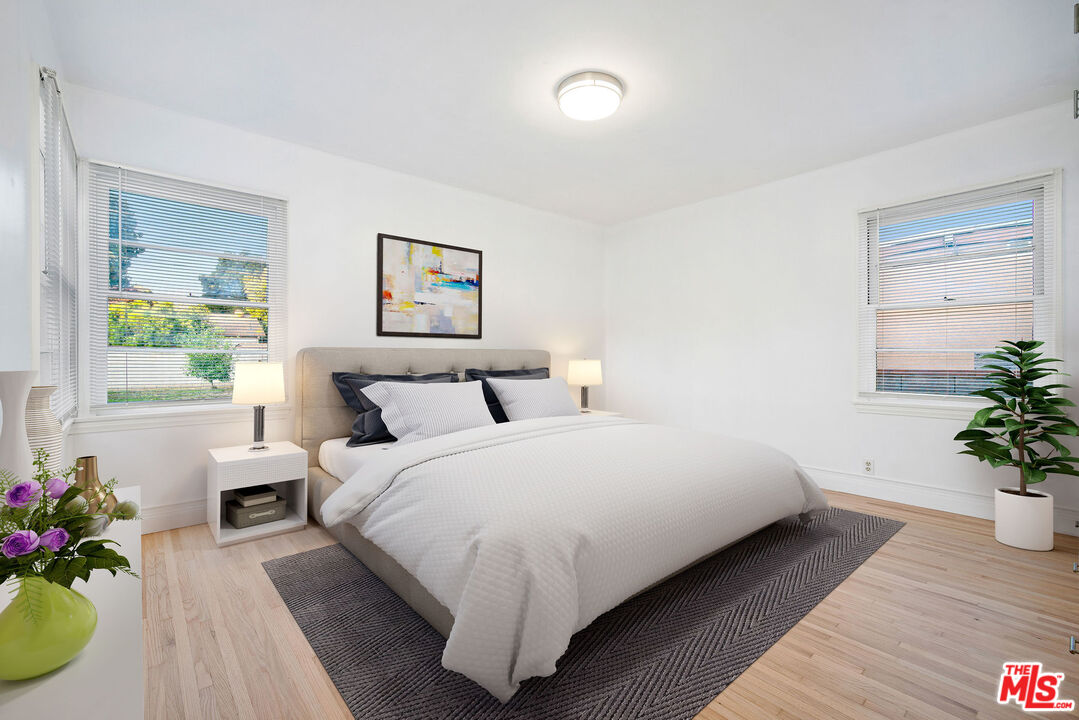 1924 Armacost Avenue Los Angeles, CA 90025 - Photo 22 of 33 a large white bed sitting in a bedroom next to a window