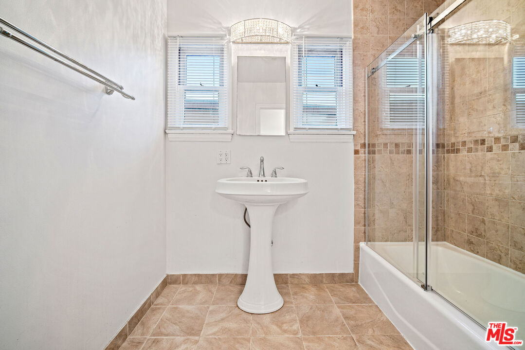 1924 Armacost Avenue Los Angeles, CA 90025 - Photo 26 of 33 a bathroom with a sink a toilet and bathtub