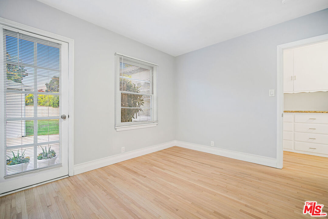 1924 Armacost Avenue Los Angeles, CA 90025 - Photo 29 of 33 an empty room with wooden floor and windows