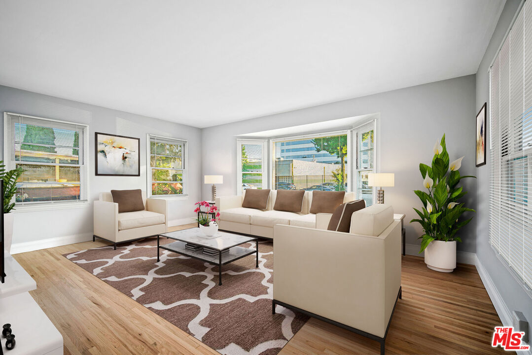 1924 Armacost Avenue Los Angeles, CA 90025 - Photo 5 of 33 a living room with furniture and a potted plant