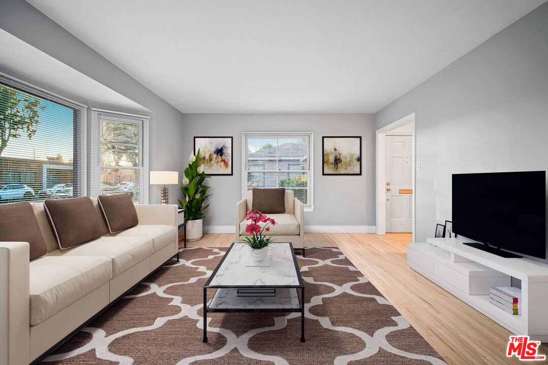 1924 Armacost Avenue Los Angeles, CA 90025 - Photo 7 of 33 a living room with furniture and a flat screen tv