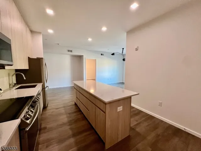 a kitchen with stainless steel appliances a stove and a refrigerator