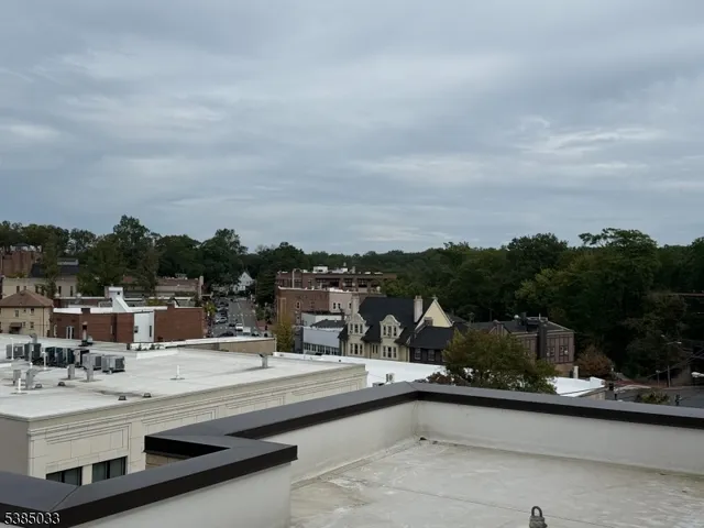 a view of swimming pool that has couches and sky view