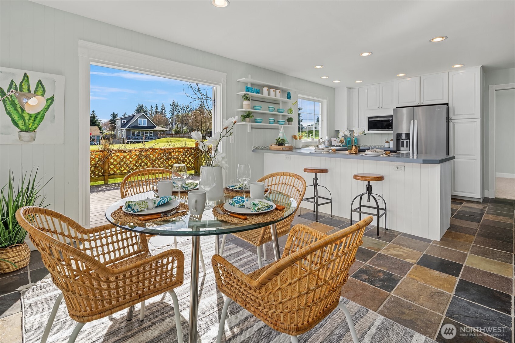 1316 East Backswing Lane Freeland, WA 98249 - Photo 15 of 37 a dining room filled chandelier and wooden floor