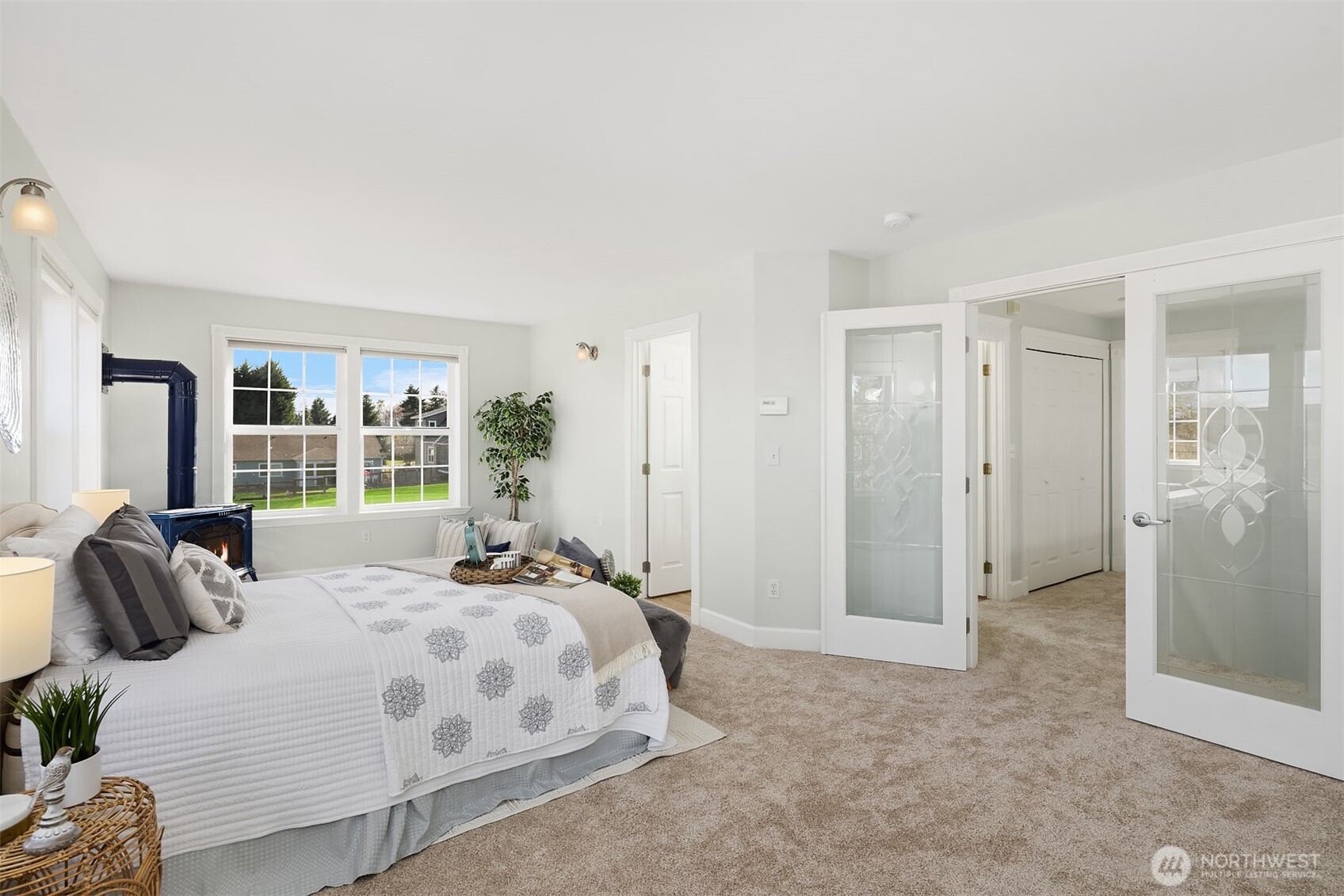 1316 East Backswing Lane Freeland, WA 98249 - Photo 24 of 37 a bedroom with a bed and a large mirror