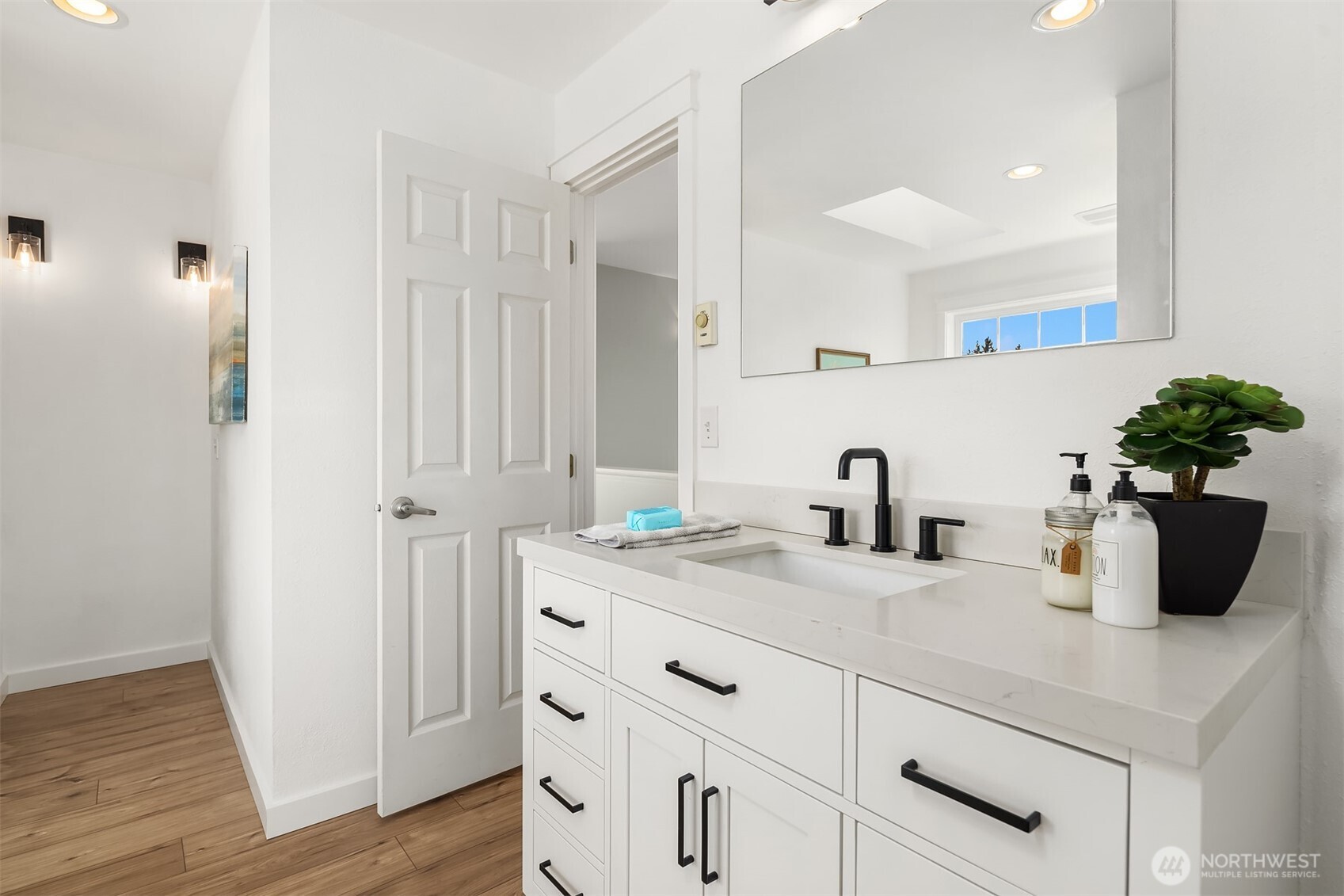 1316 East Backswing Lane Freeland, WA 98249 - Photo 28 of 37 a bathroom with a sink a potted plant and wooden floor