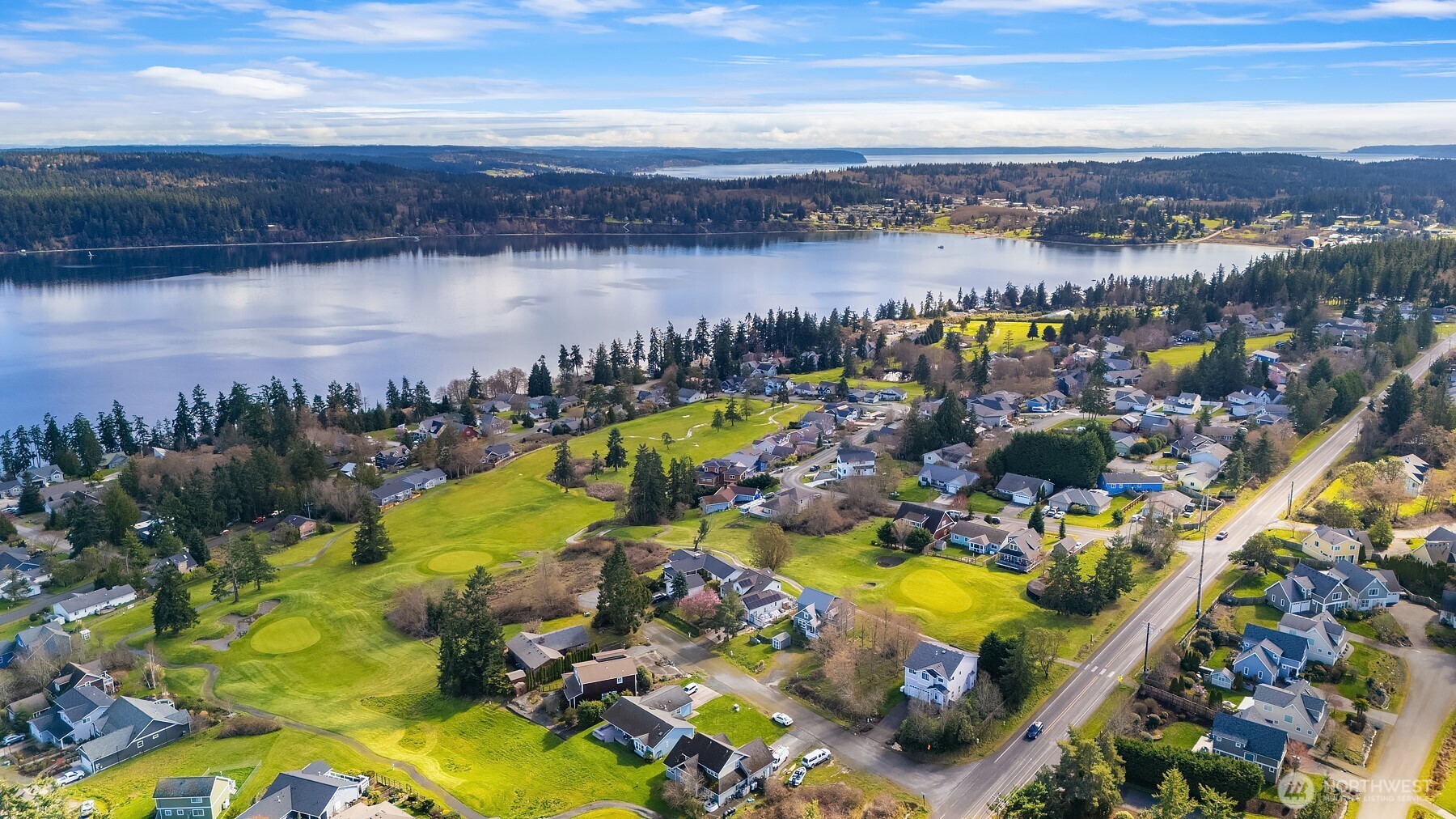 1316 East Backswing Lane Freeland, WA 98249 - Photo 36 of 37 an aerial view of a resort with swimming pool and outdoor seating