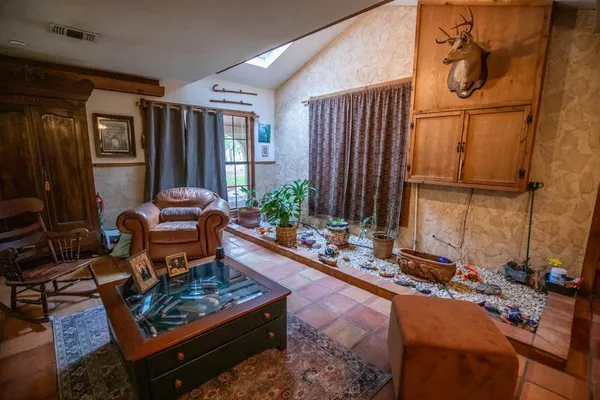 a living room with furniture a rug and a window