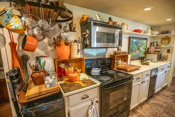 a kitchen with stainless steel appliances a stove a sink and a microwave