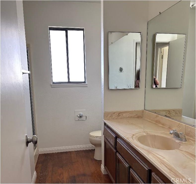 11556 3rd Hesperia, CA 92345 - Photo 16 of 24 a bathroom with a sink and mirror with toilet