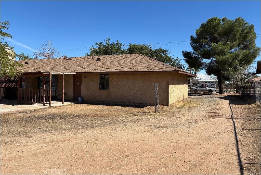 11556 3rd Hesperia, CA 92345 - Photo 22 of 24 a front view of a house with a yard and garage