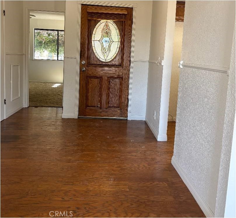 11556 3rd Hesperia, CA 92345 - Photo 4 of 24 a view of a hallway with entryway wooden floor and front door