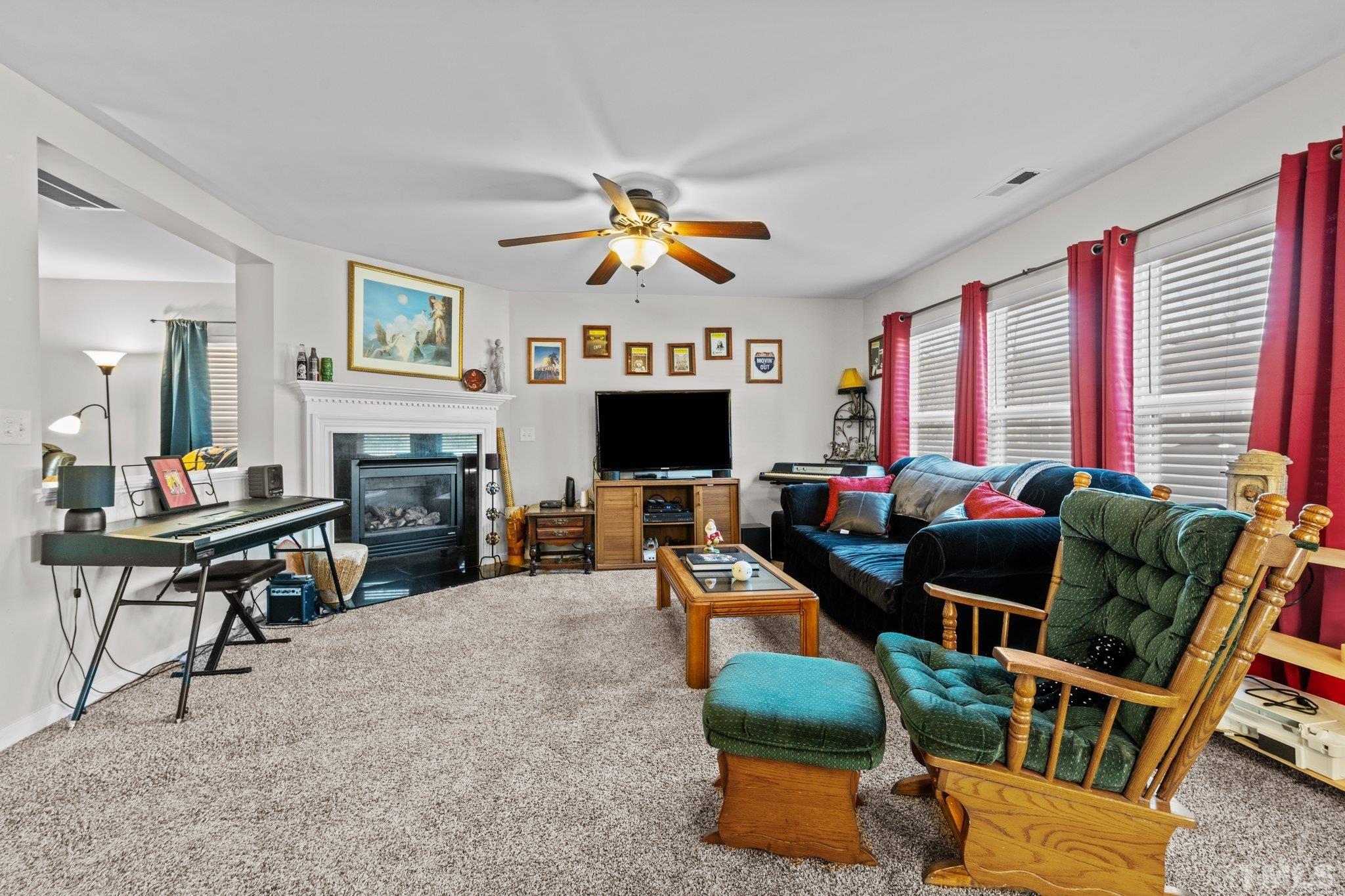 2447 Quarry Ridge Lane Raleigh, NC 27610 - Photo 11 of 44 a living room with furniture fireplace and flat screen tv