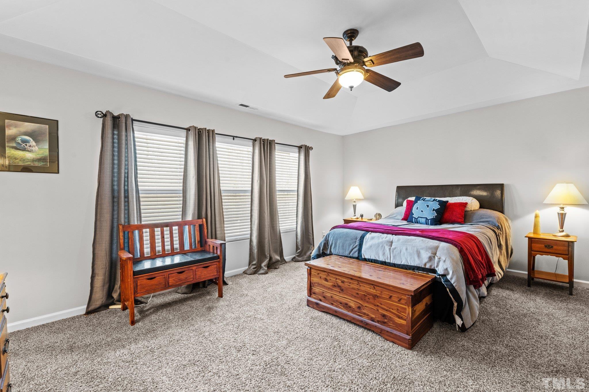 2447 Quarry Ridge Lane Raleigh, NC 27610 - Photo 20 of 44 a bedroom with a bed and a ceiling fan