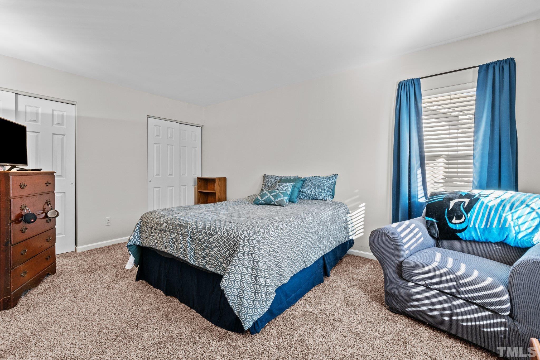 2447 Quarry Ridge Lane Raleigh, NC 27610 - Photo 24 of 44 a bedroom with a bed and a couch