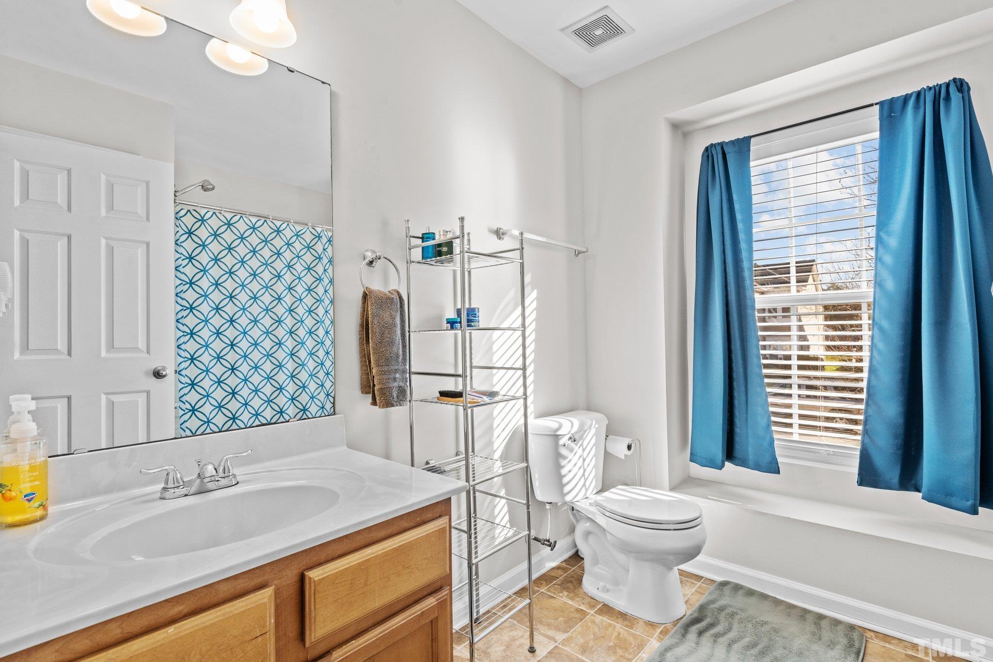 2447 Quarry Ridge Lane Raleigh, NC 27610 - Photo 26 of 44 a bathroom with a sink toilet and shower