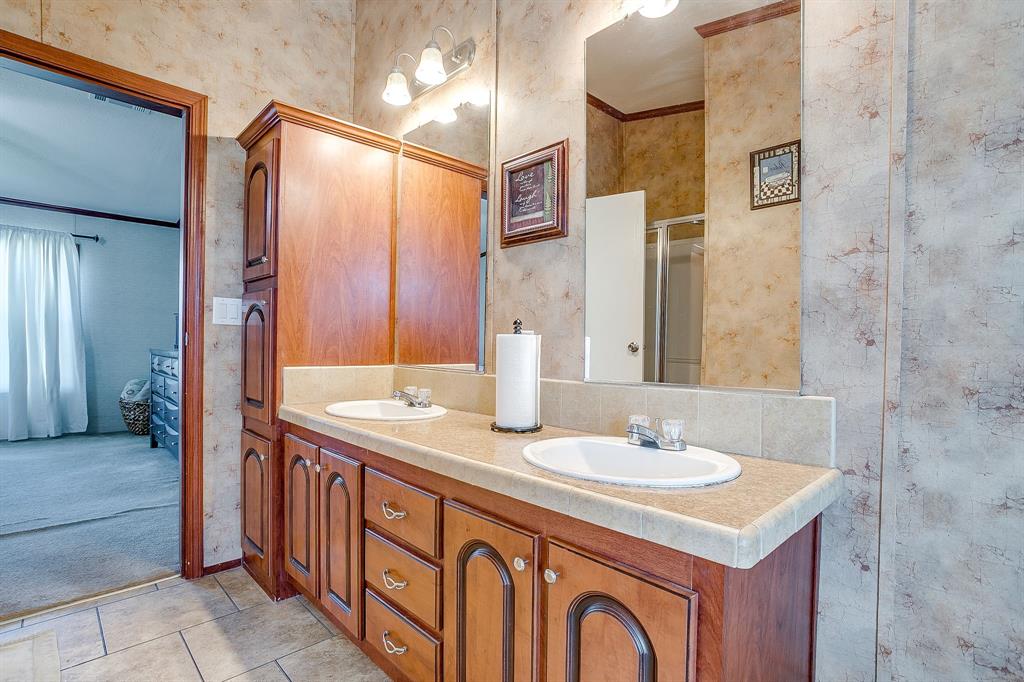 321 Young Road Millsap, TX 76066 - Photo 20 of 28 a bathroom with a sink and a mirror