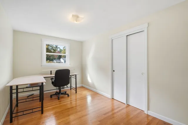 a view of a workspace with wooden floor and a workspace