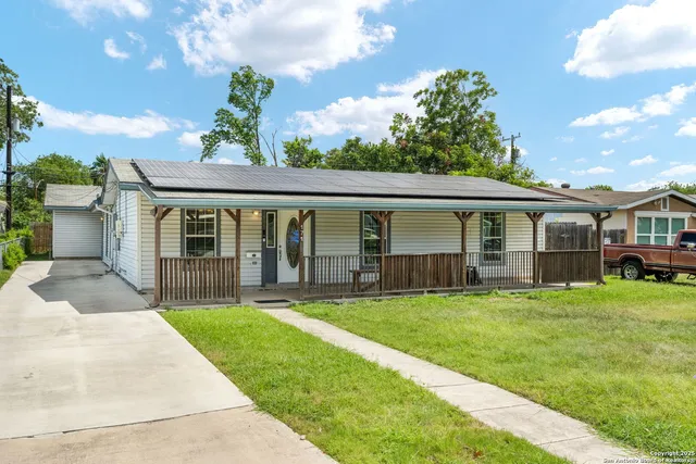 a view of a house with a yard and porch