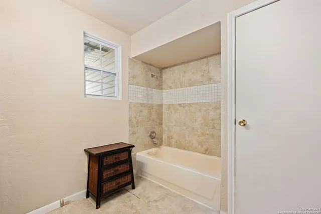 a bathroom with a bathtub and a shower