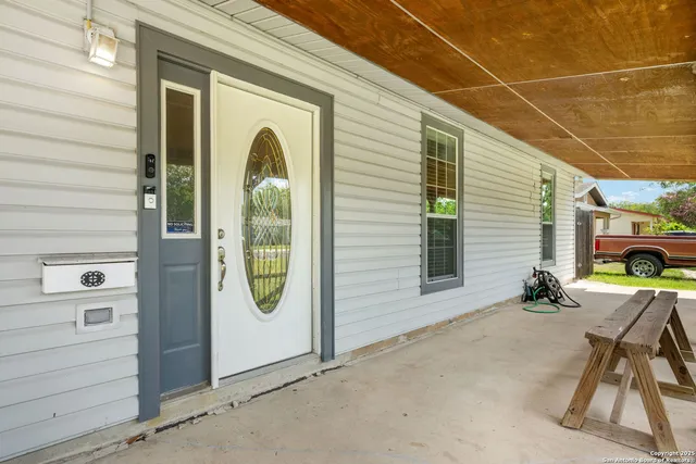 a view of a door and chair in the patio