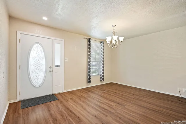 a view of a room with wooden floor and natural light