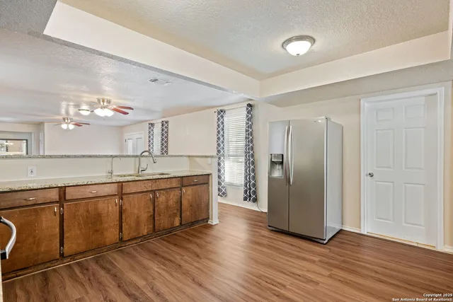 a large bathroom with a large mirror vanity and a sink