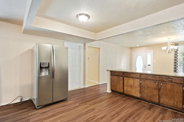 a view of a kitchen counter space and wooden floor
