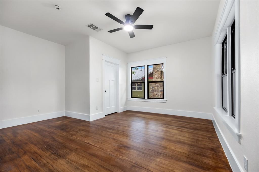 1014 Bolivar Street Denton, TX 76201 - Photo 26 of 36 an empty room with wooden floor and windows