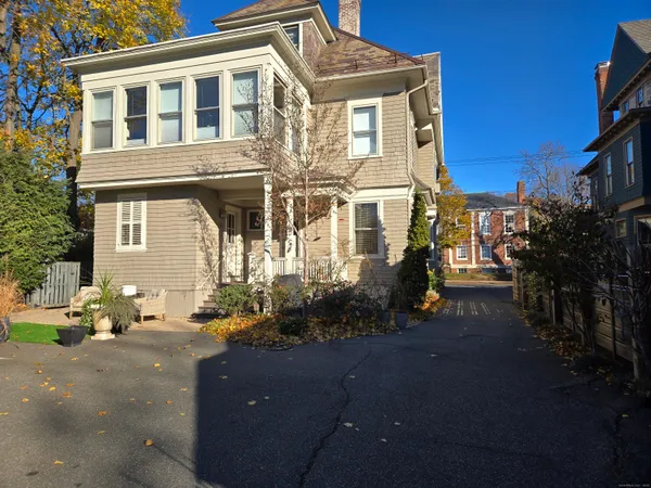 a front view of a house with trees