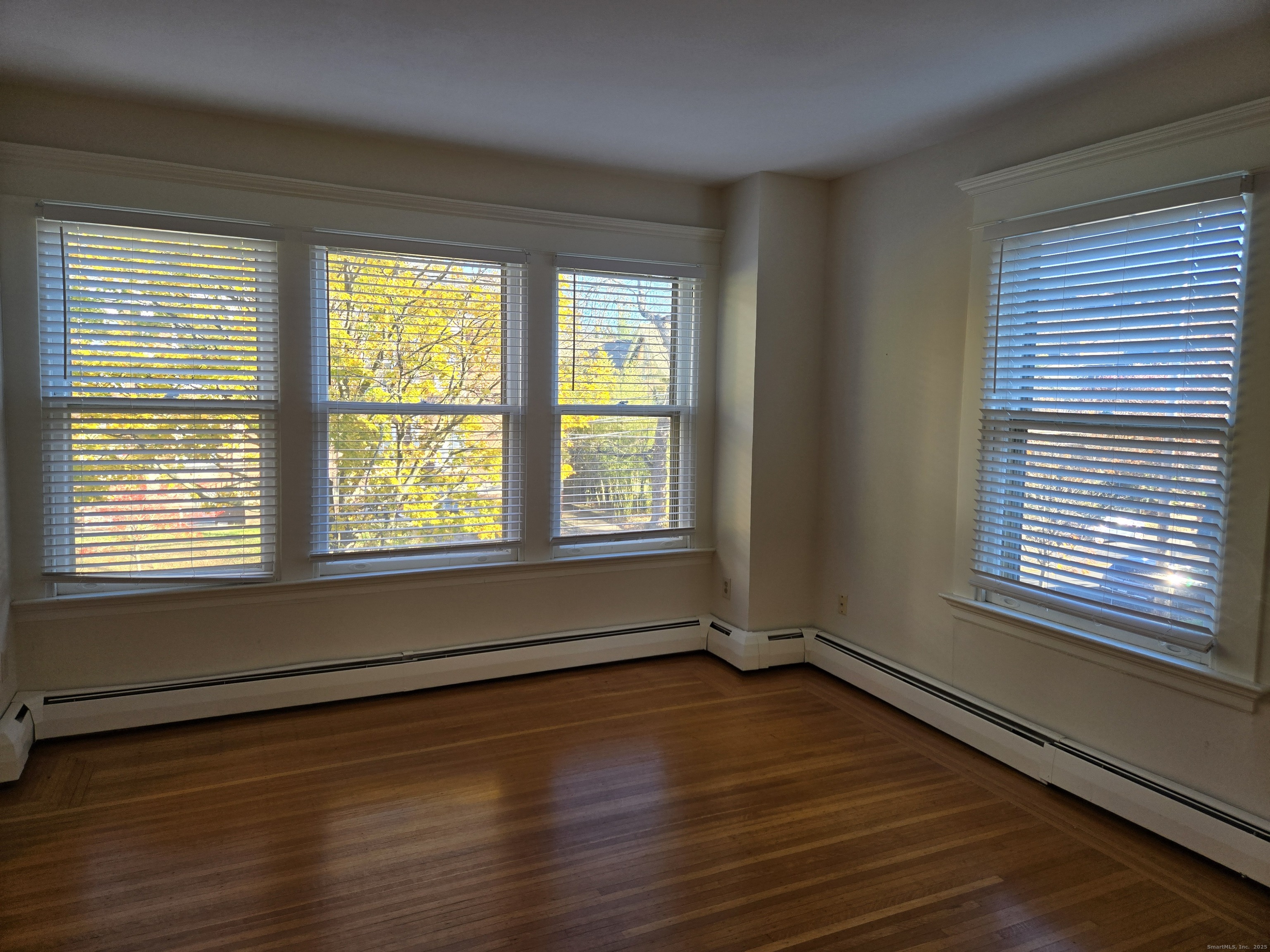 188 Cold Spring Street, Unit 3 New Haven, CT 06511 - Photo 13 of 20 a view of an empty room with wooden floor and a window