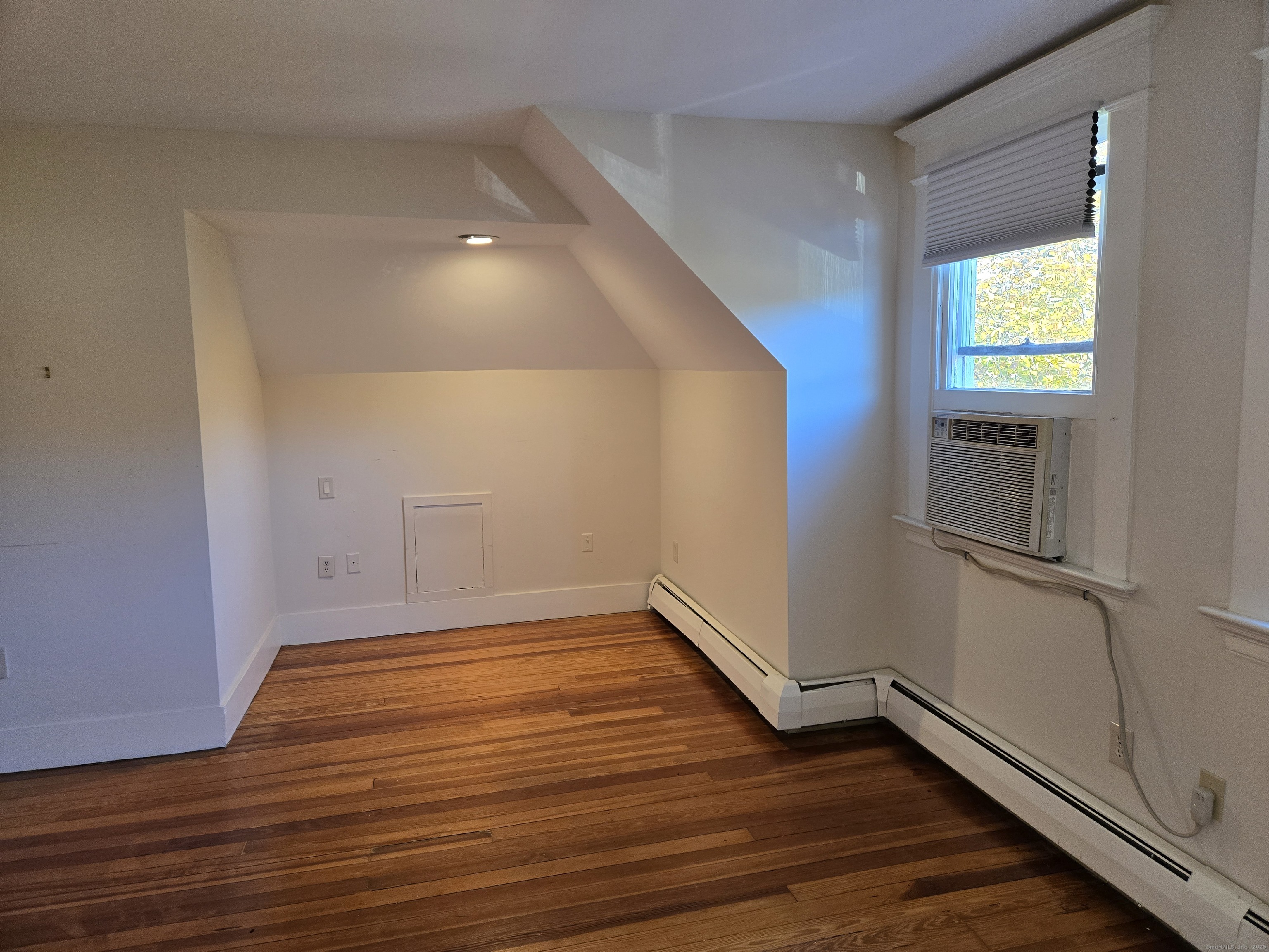 188 Cold Spring Street, Unit 3 New Haven, CT 06511 - Photo 14 of 20 a view of an empty room with wooden floor and a window