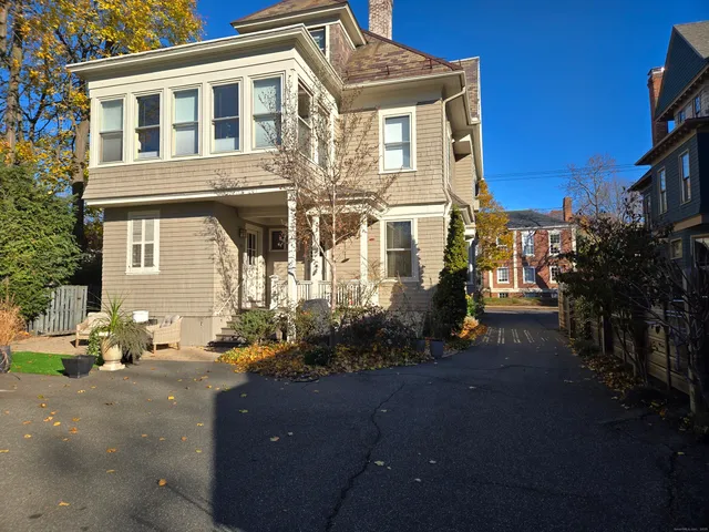 a front view of a house with trees