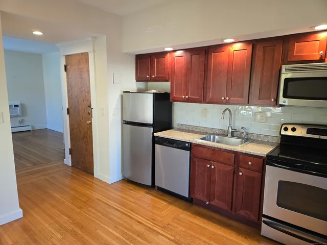 a kitchen with a sink stove and refrigerator