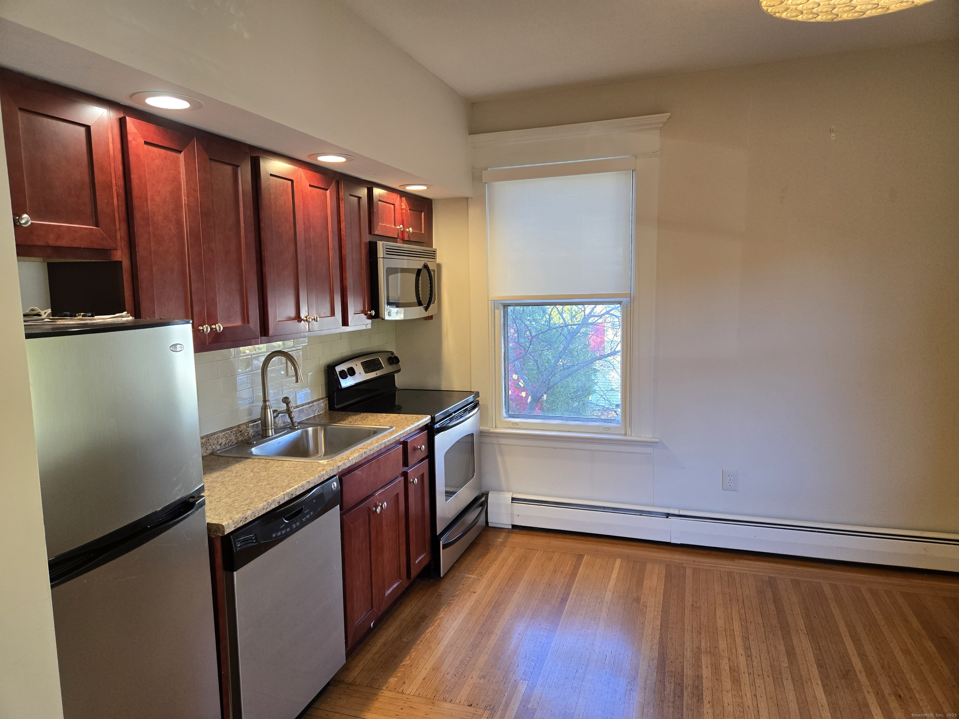 188 Cold Spring Street, Unit 3 New Haven, CT 06511 - Photo 6 of 20 a kitchen with a sink wooden cabinets and a window